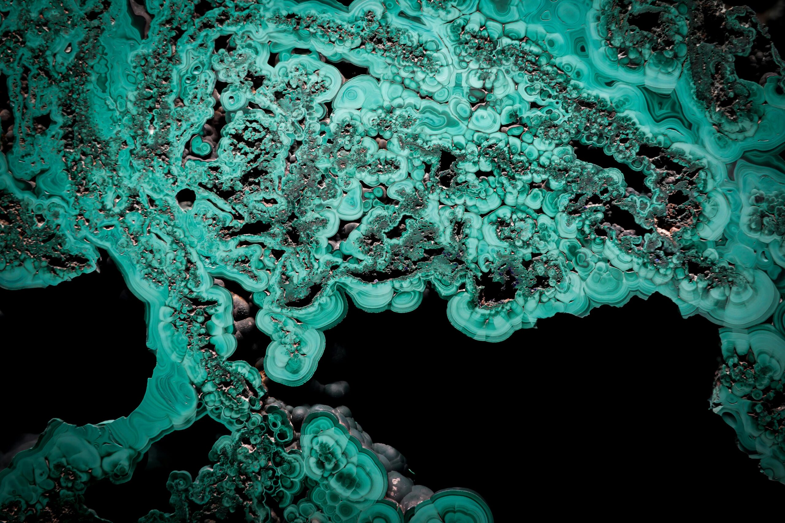 Abstract image showing intricate malachite patterns and textures in vivid green.